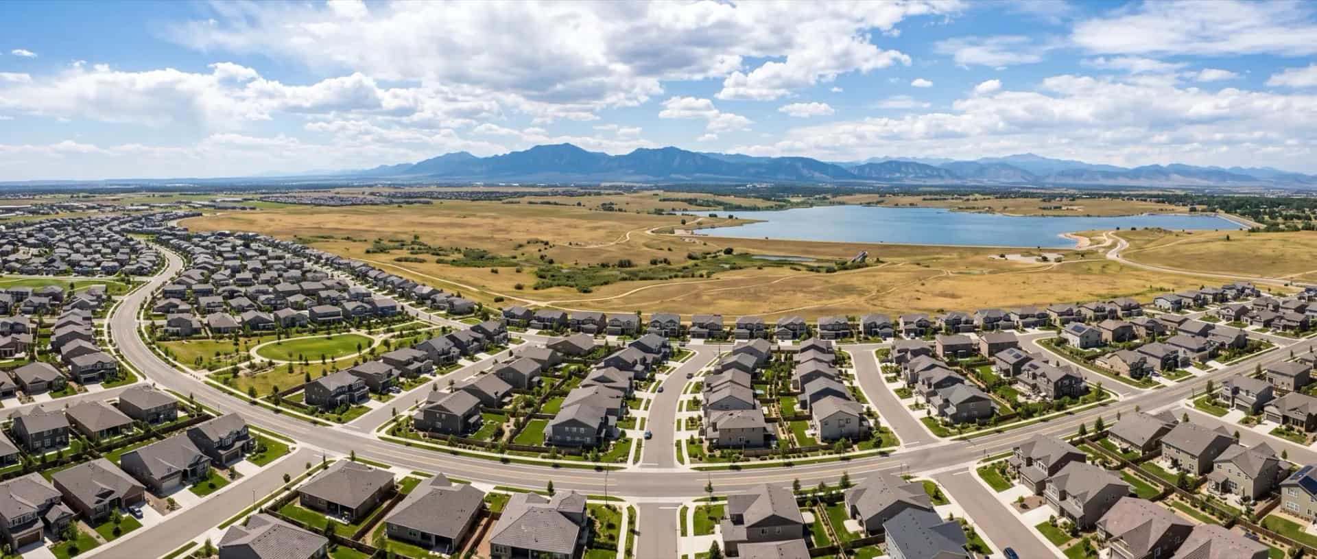 Illustrative representation of a newer master-planned neighborhood in Broomfield, Colorado with open space and a reservoir beyond