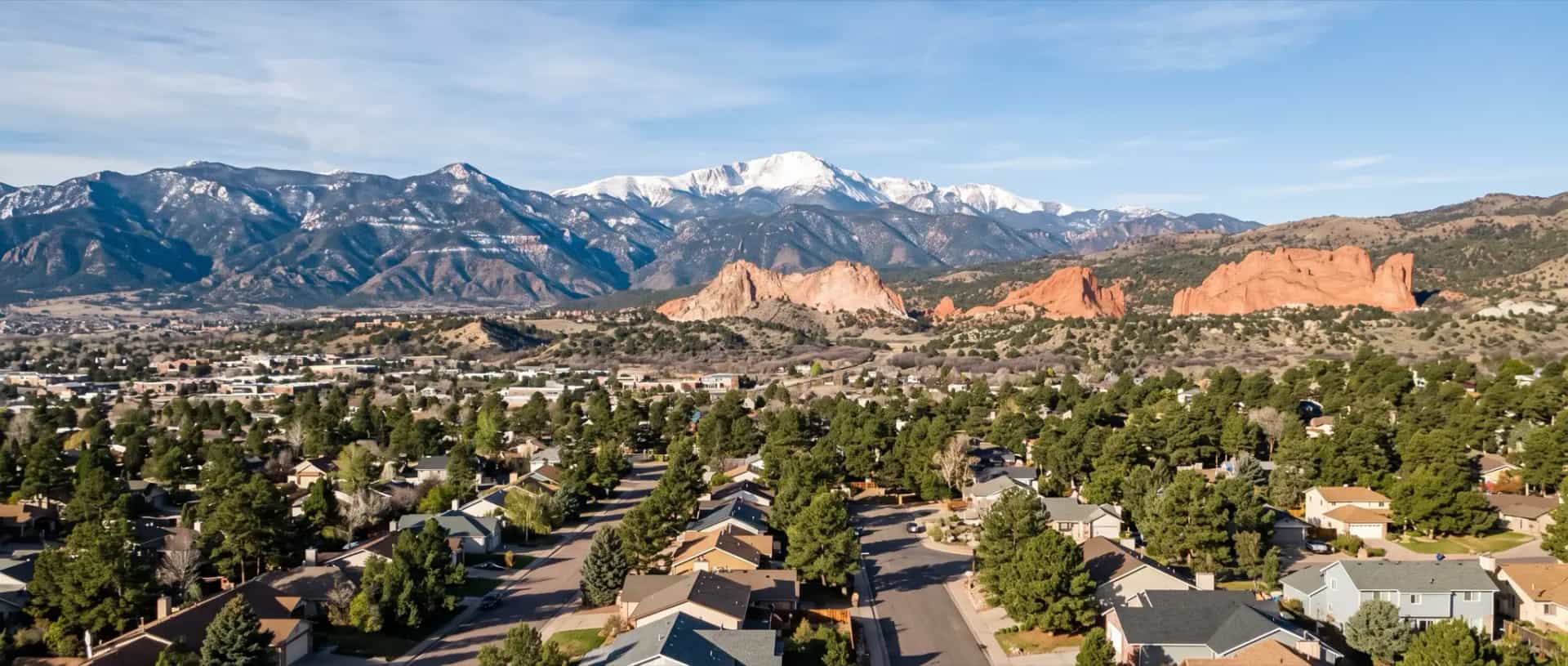 Illustrative representation of residential rooftops in Colorado Springs, Colorado with Pikes Peak dominating the western skyline