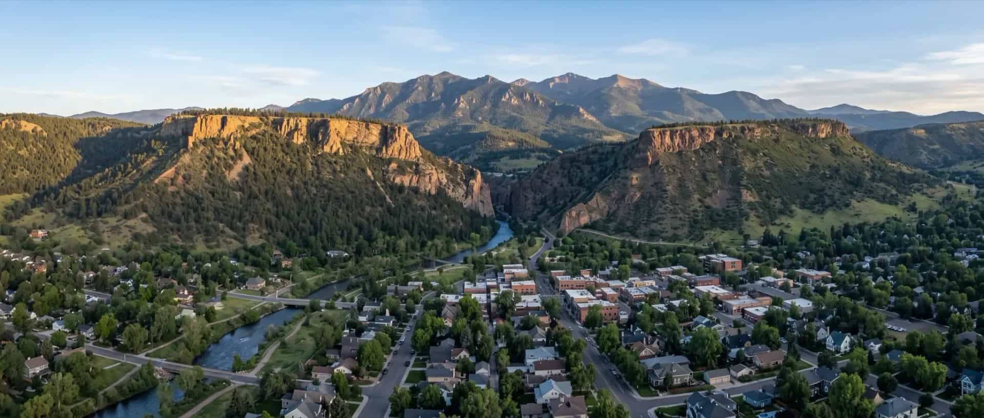 Illustrative representation of rooftops in the valley at Golden, Colorado between the flat-topped Table Mountain mesas