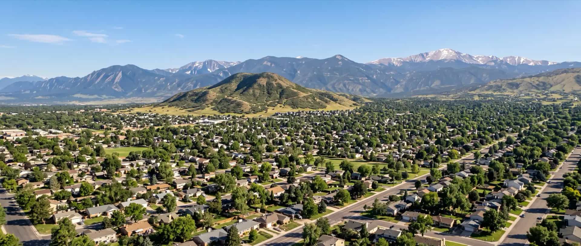 Illustrative representation of mid-century suburban rooftops in Lakewood, Colorado with Green Mountain and the foothills behind