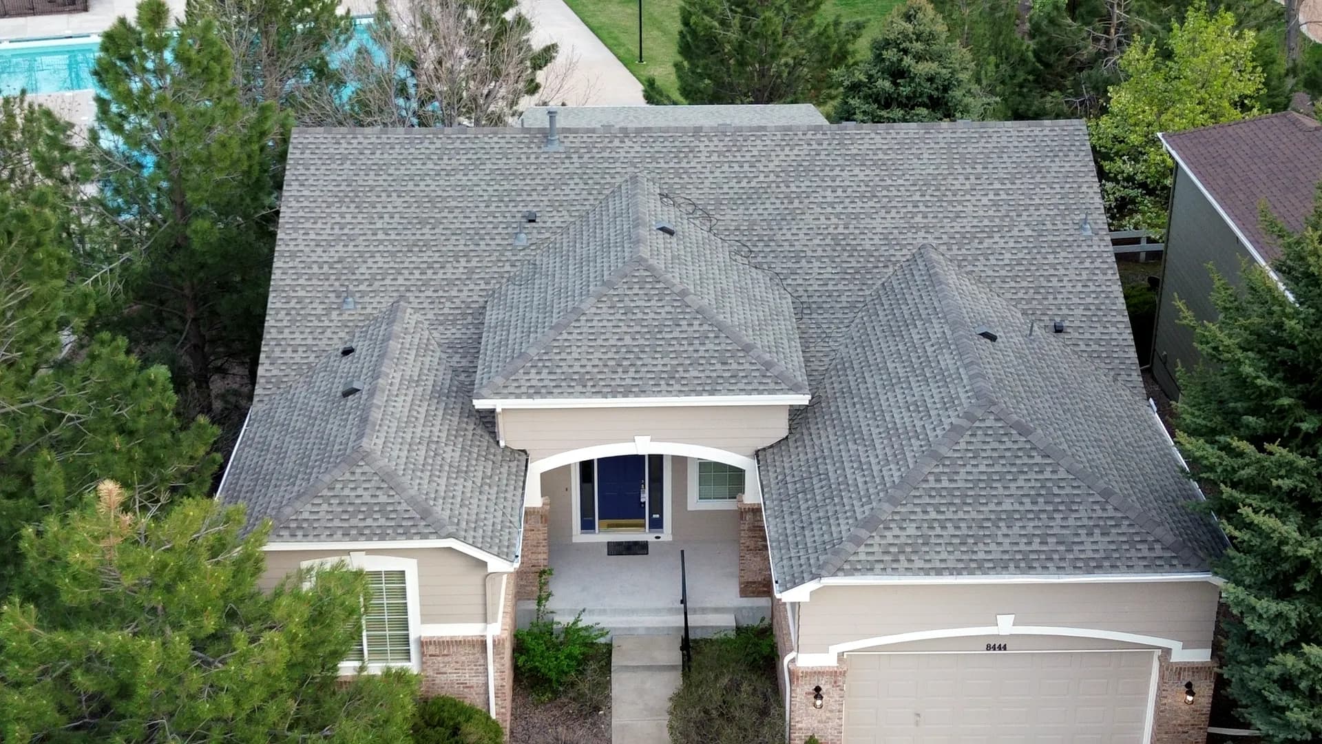 Aerial drone view of a completed architectural asphalt shingle roof replacement on a home in Castle Rock, Colorado