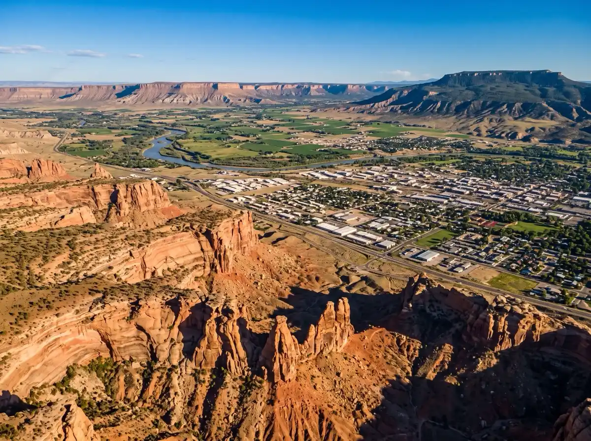 Illustrative representation of Colorado's Western Slope, with the red sandstone canyons of Colorado National Monument above the Grand Valley and the Book Cliffs beyond