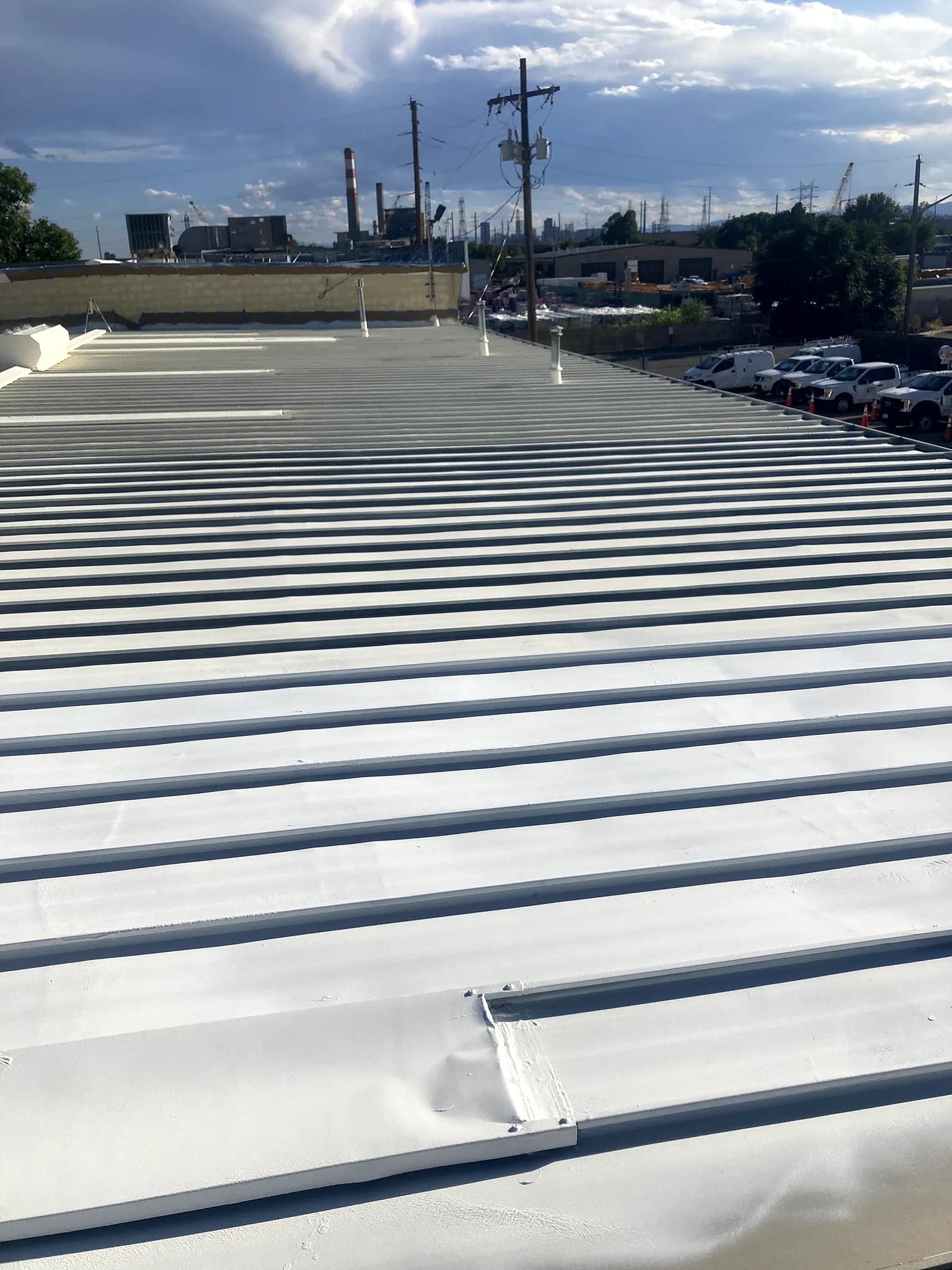 Finished bright white reflective American WeatherStar coated metal roof on a commercial building in Denver, Colorado