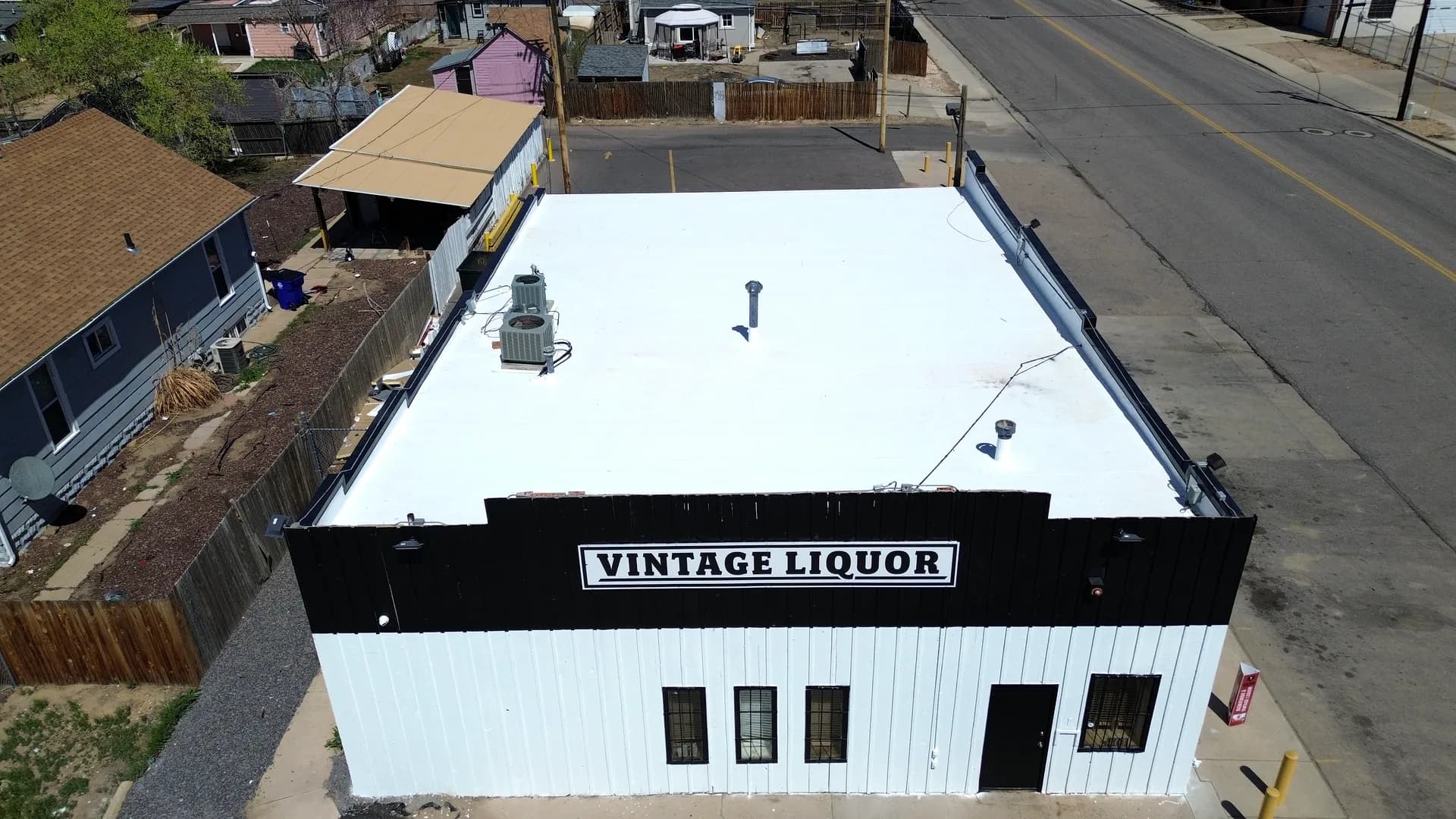Completed bright white Johns Manville TPO membrane roof on the Vintage Liquor building in Greeley, Colorado