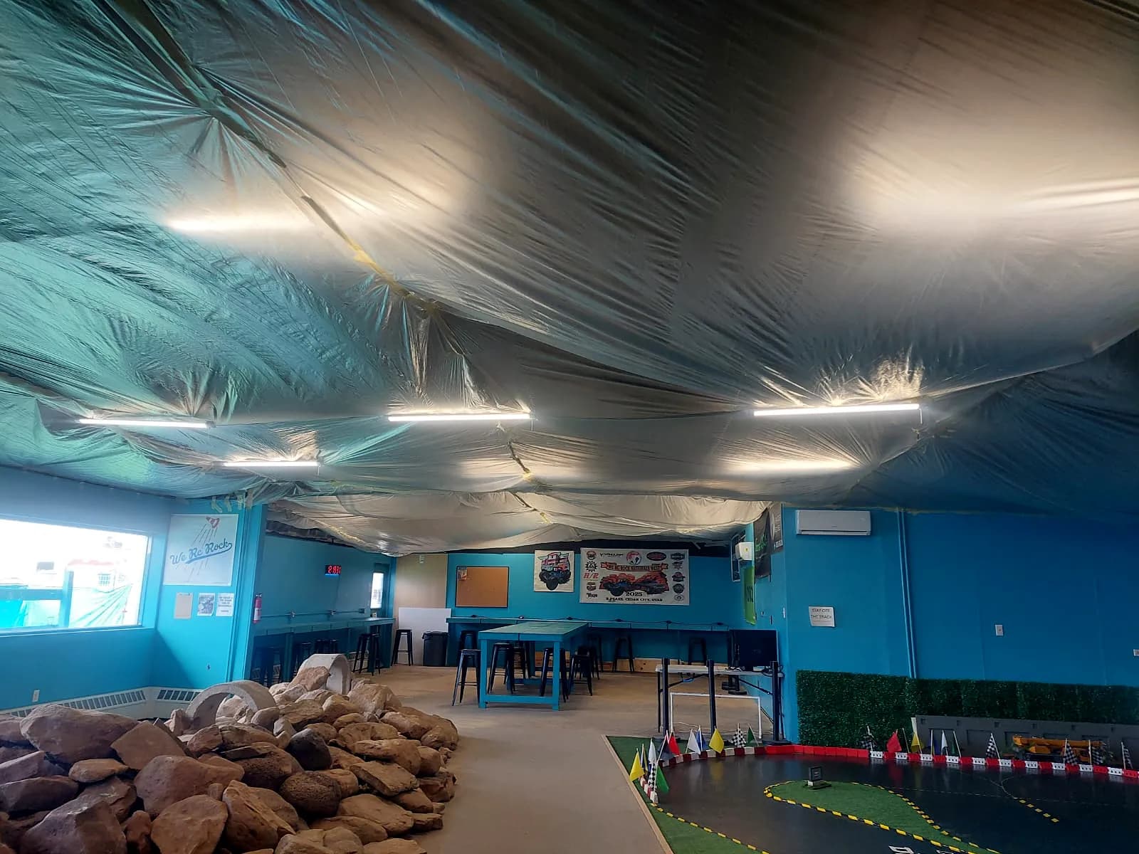 Protective sheeting covering a tenant space during a commercial roof recover project in Grand Junction, Colorado