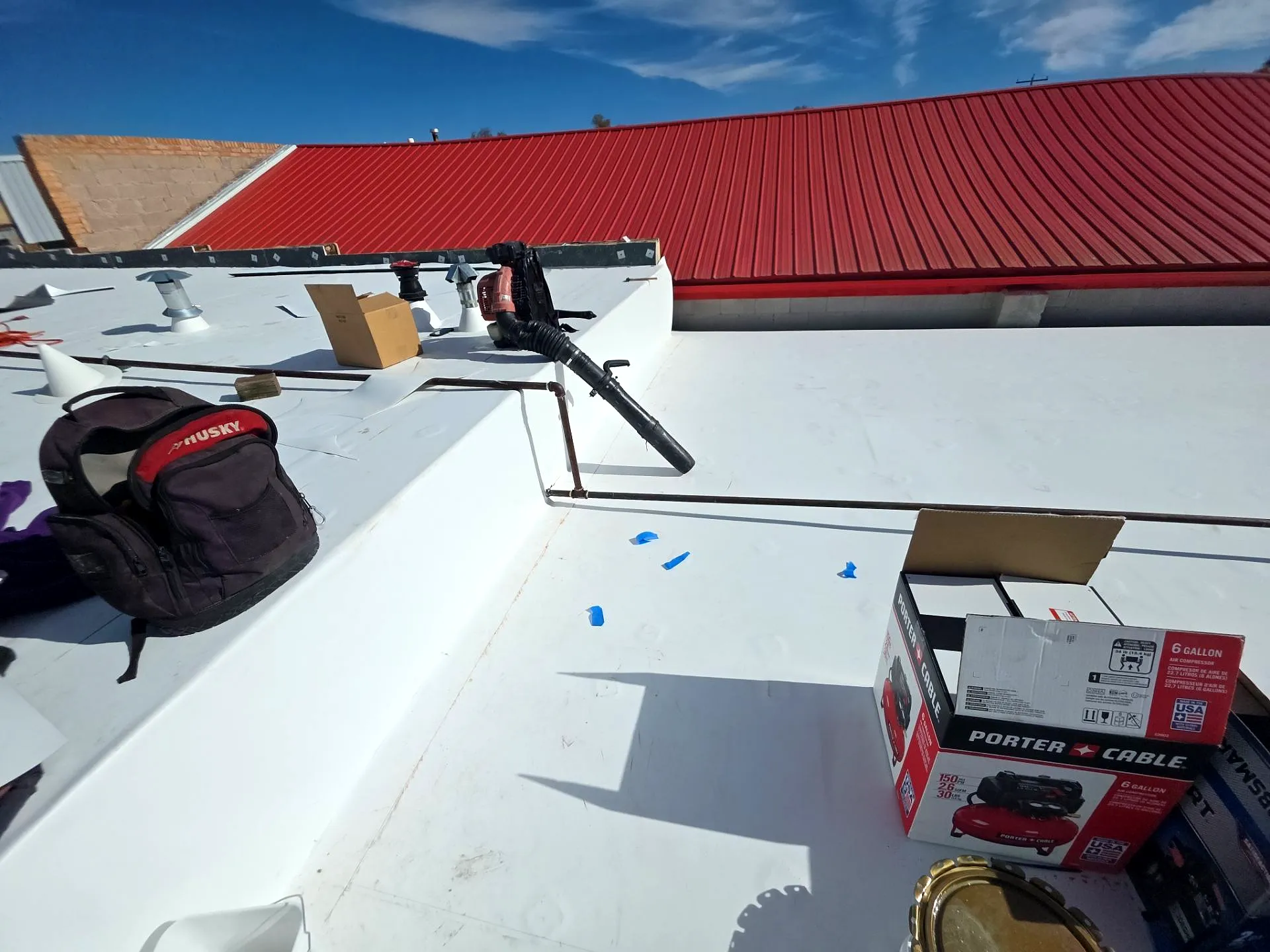 Finished 60-mil white Johns Manville TPO membrane with heat-welded seams on a commercial roof in downtown Fruita, Colorado