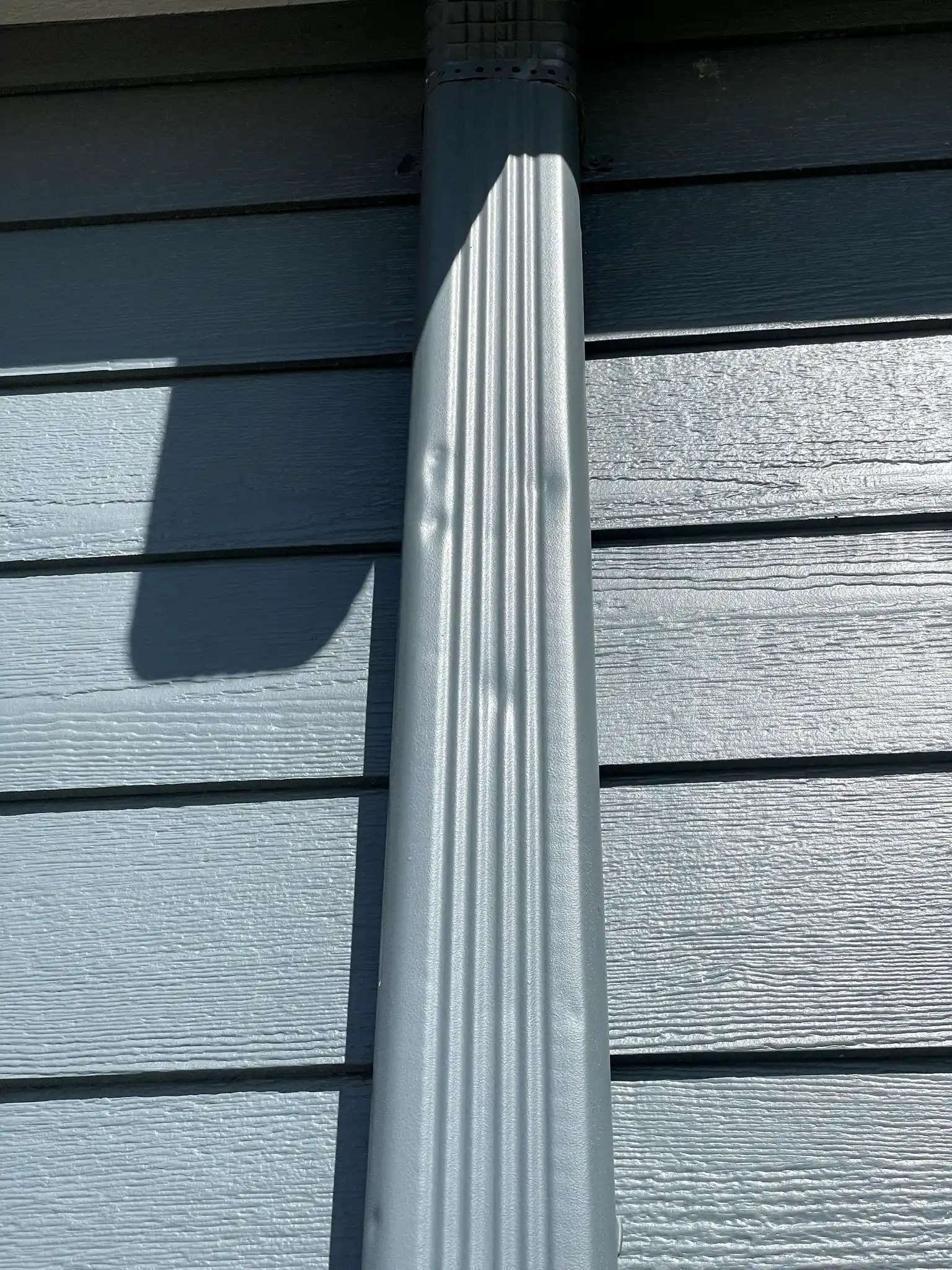 New downspout installed on an Aurora, Colorado home as part of a hail insurance claim