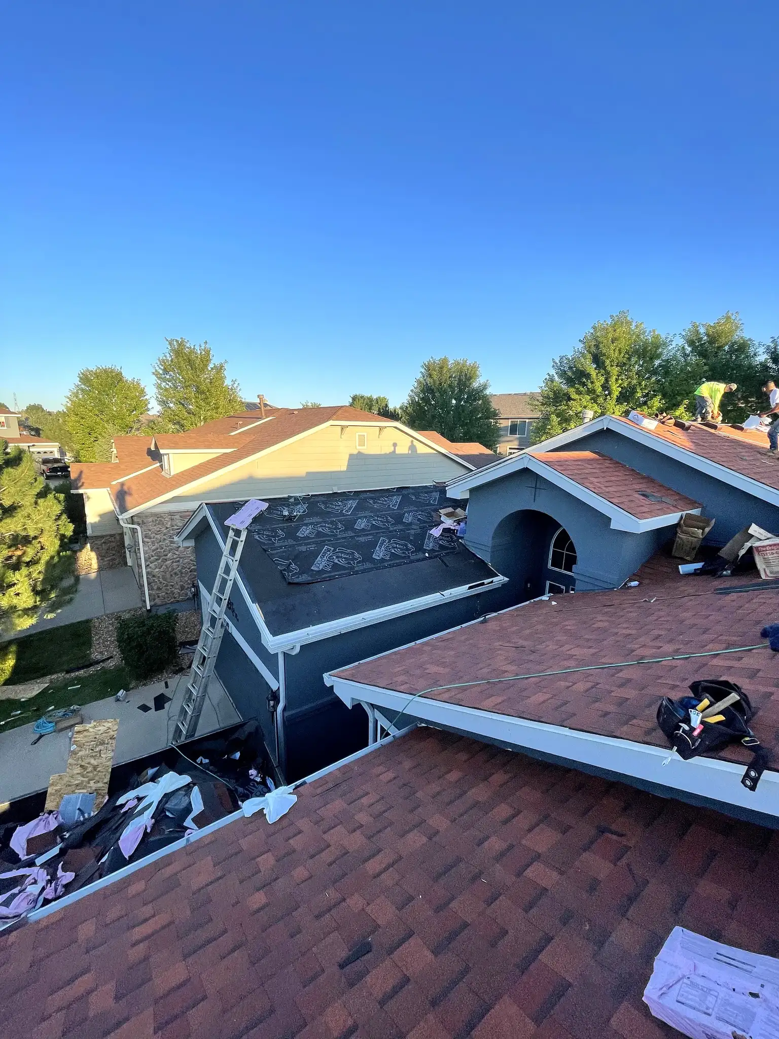 Residential roof replacement in progress with tear-off underway on a home in Aurora, Colorado