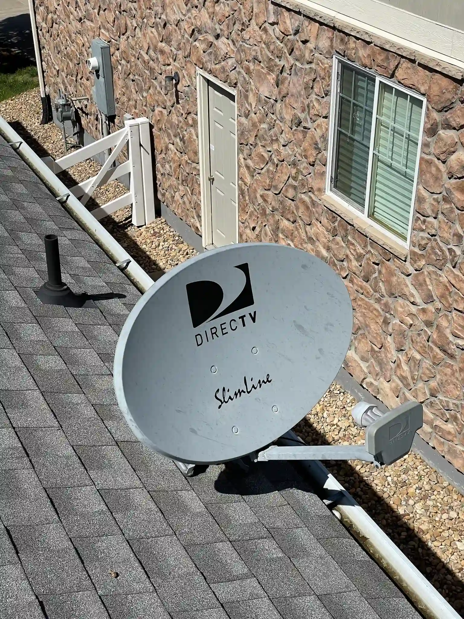 Detail of a roof penetration and mount being sealed on a residential roof in Aurora, Colorado