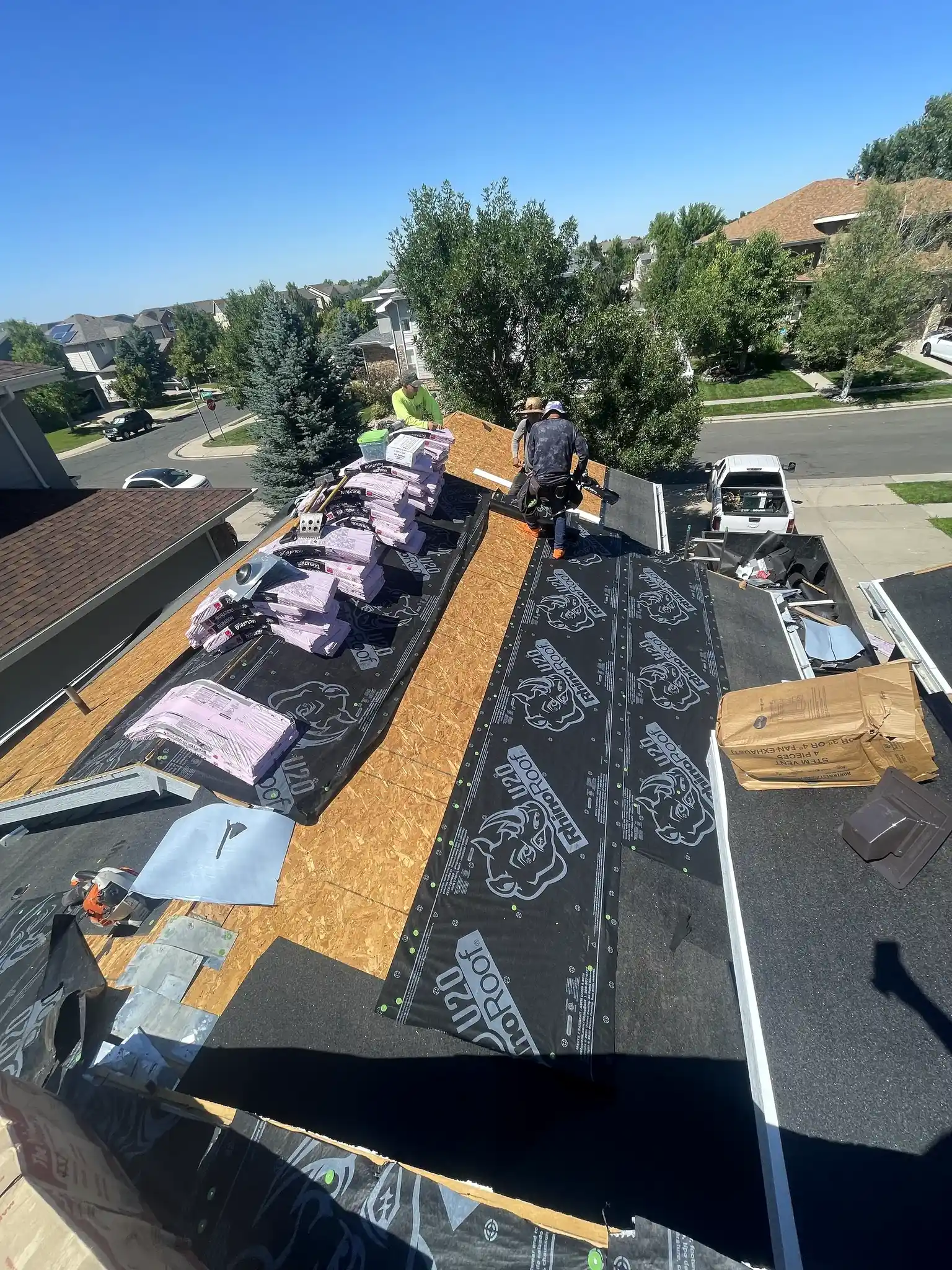 CRC crew installing shingles on a residential roof in Aurora, Colorado
