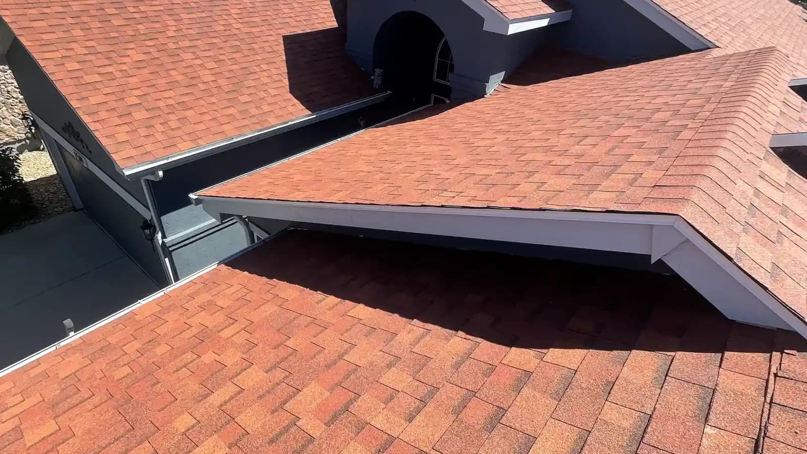 Aerial view of a completed shingle roof with dormers on a residential home in Aurora, Colorado after a hail insurance reroof