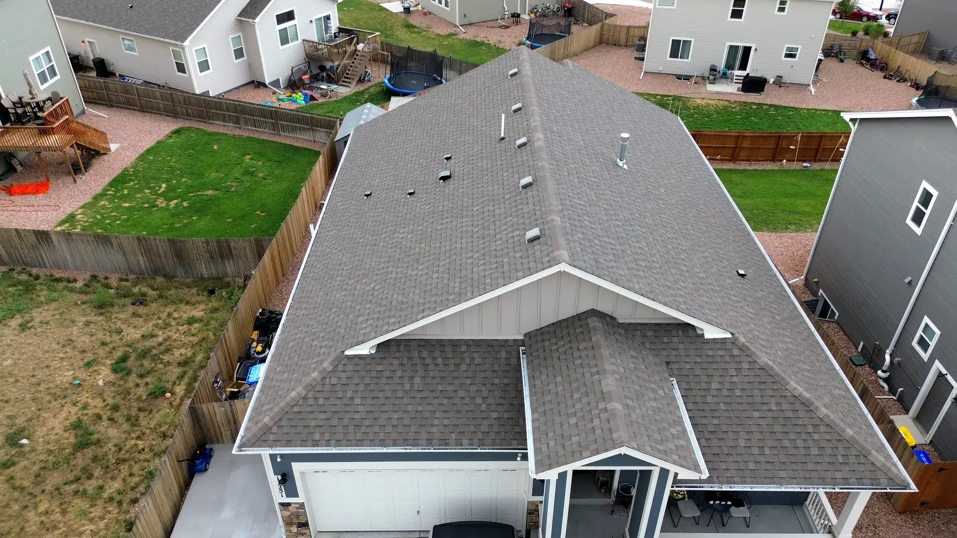 Aerial view of the completed architectural shingle roof on the front of a two-story home in Colorado Springs, Colorado