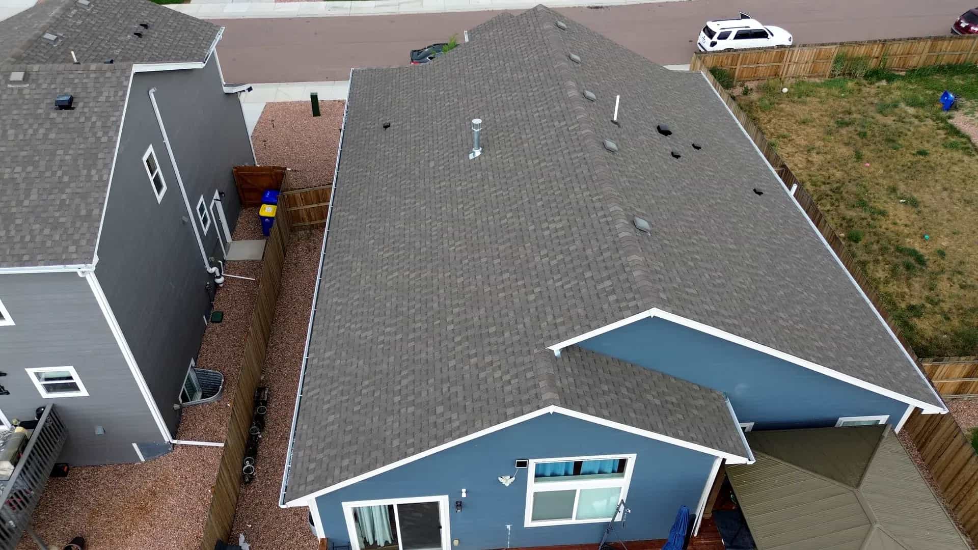 Aerial drone view of a completed residential shingle roof replacement on a home in Colorado Springs, Colorado