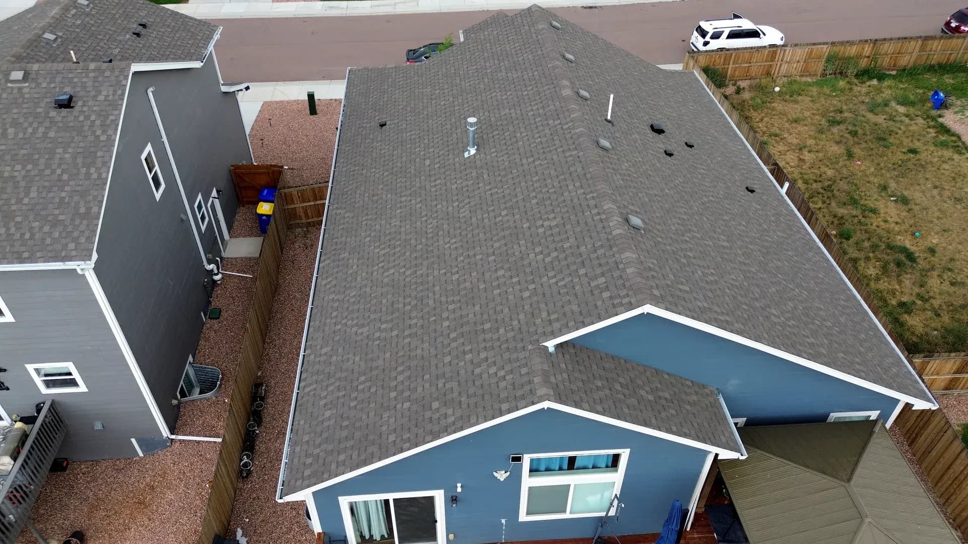 Completed architectural asphalt shingle roof on a two-story home in Colorado Springs, Colorado after a hail insurance reroof