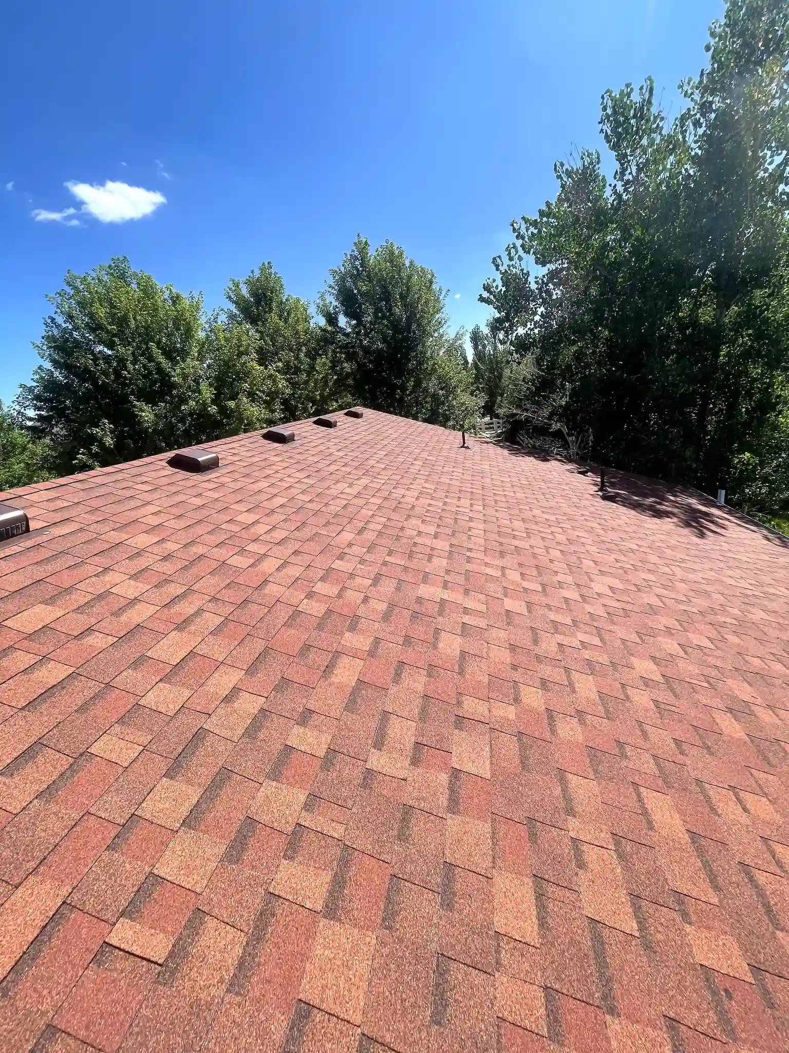 Completed residential shingle roof with a clean ridge line on a home in Aurora, Colorado