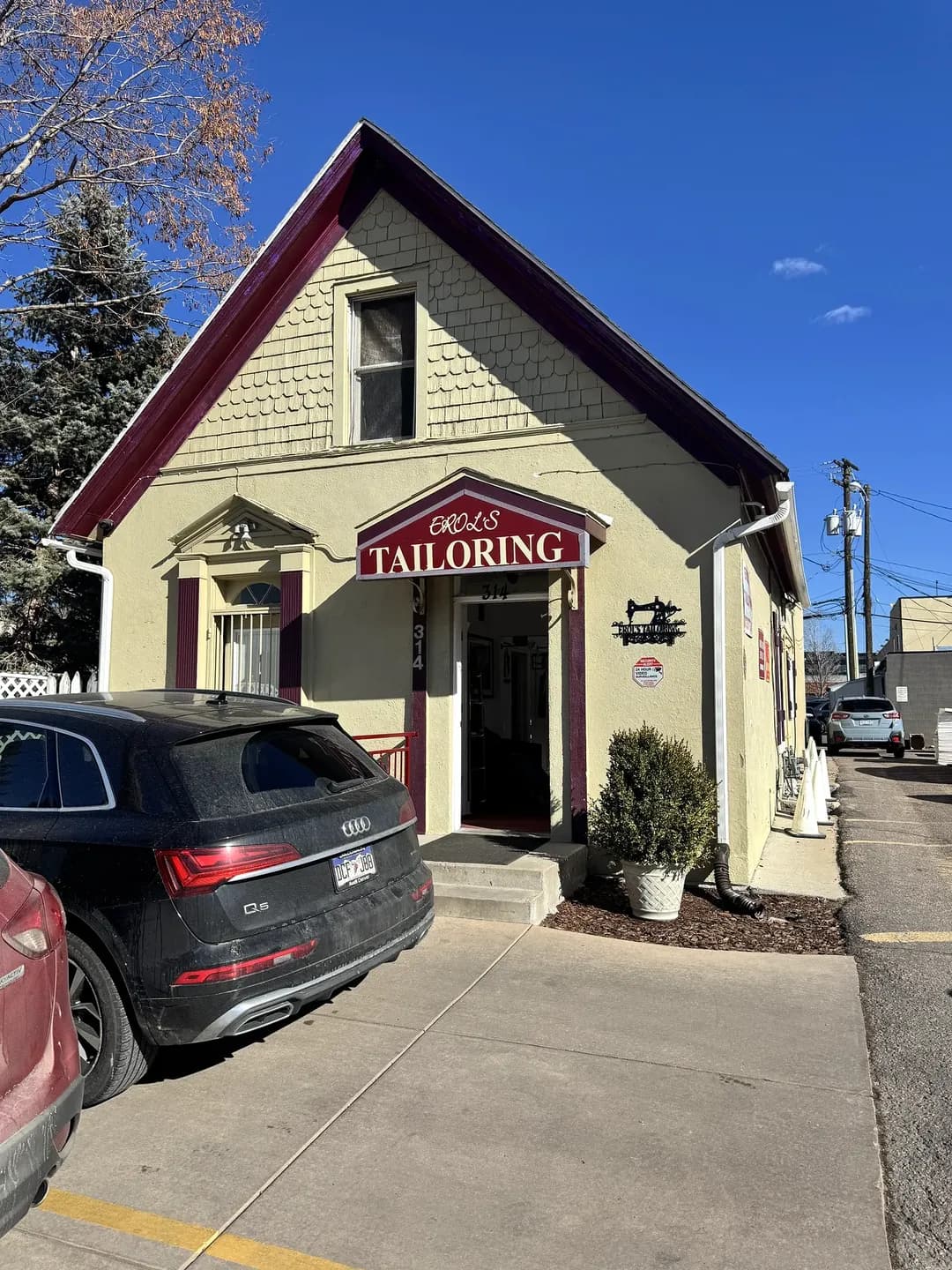 Front entrance of Erol's Tailoring and Alterations, a converted older house in the Cherry Creek North neighborhood of Denver, Colorado, before its roof replacement