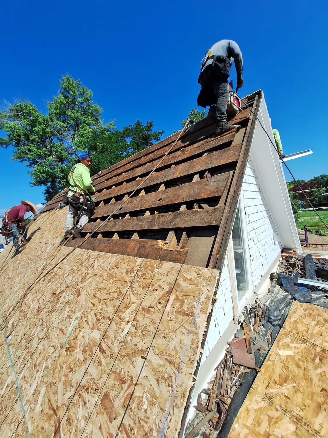New OSB roof decking installed around a dormer window on an older house in Denver, Colorado, during a full roof replacement