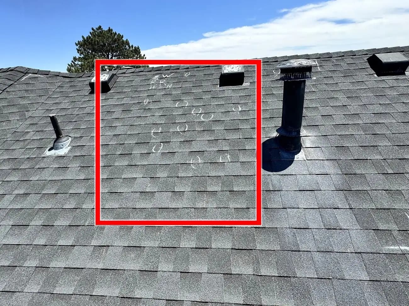 A chalk-marked hail test square on an old asphalt shingle roof in Elizabeth, Colorado, with individual hail impacts circled for an insurance adjuster