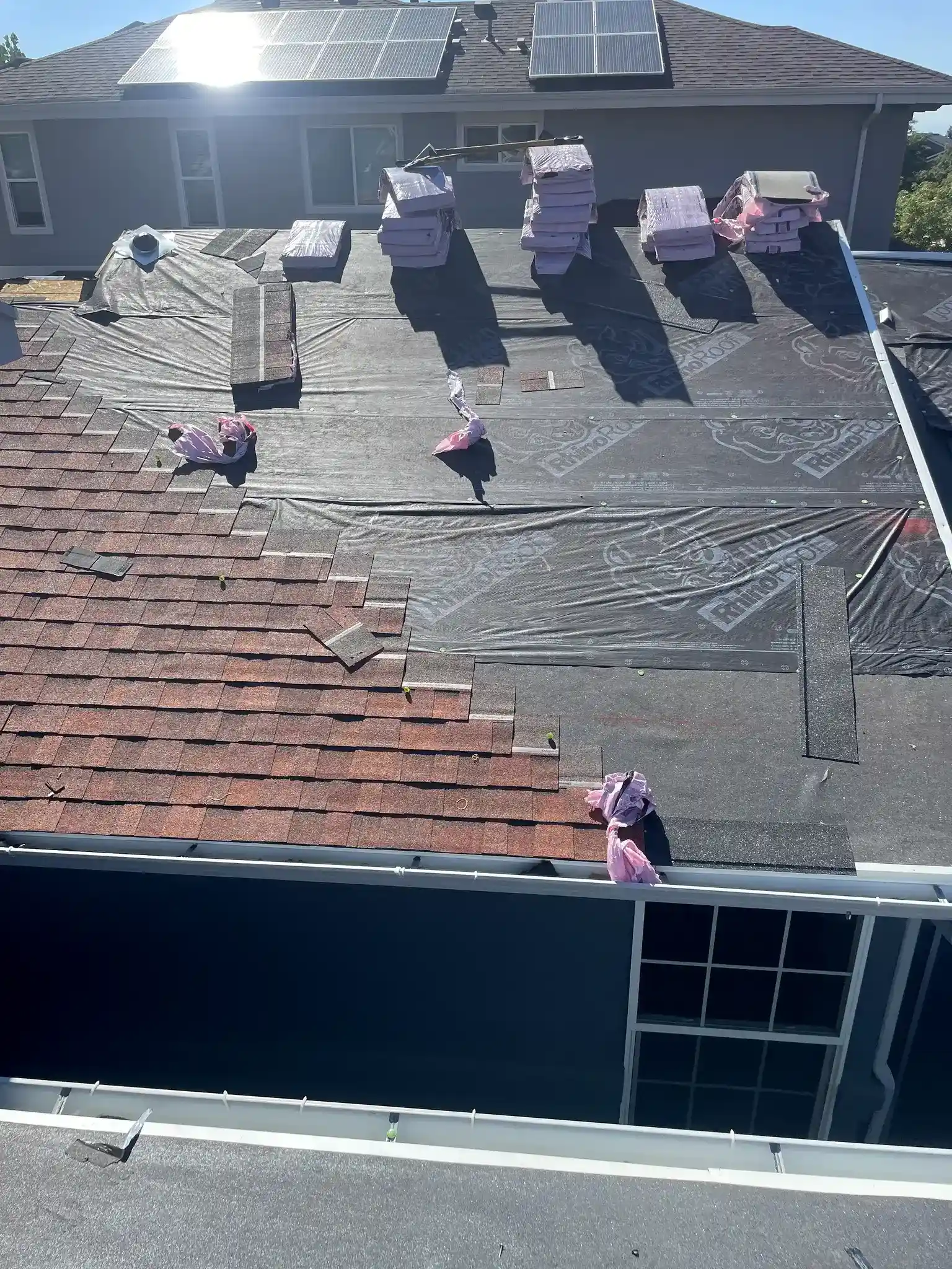 Roof tear-off with Owens Corning Duration shingles and RhinoRoof underlayment staged on an Aurora, Colorado home