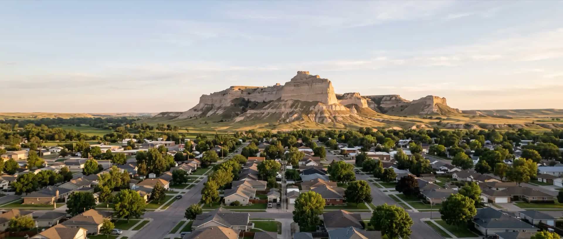 Illustrative representation of a small-city neighborhood in Gering, Nebraska beneath the sandstone bluffs of the North Platte valley
