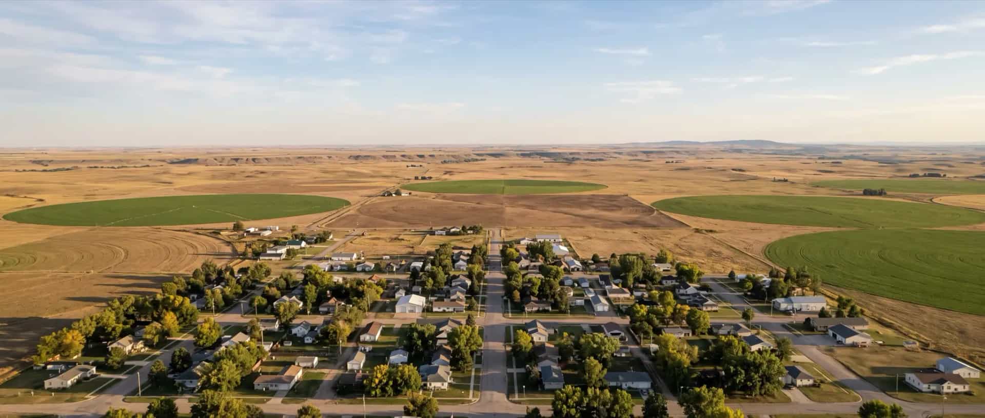 Illustrative representation of a tiny village with shelterbelt trees among irrigated fields and dry rangeland at Morrill, Nebraska